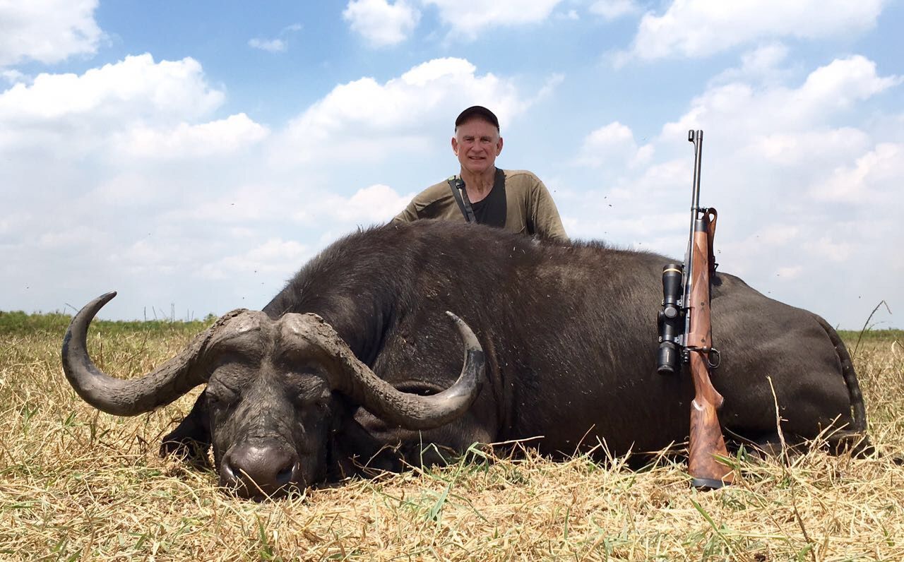 Hunting client with a Cape buffalo bull taken with Nhoro Safaris